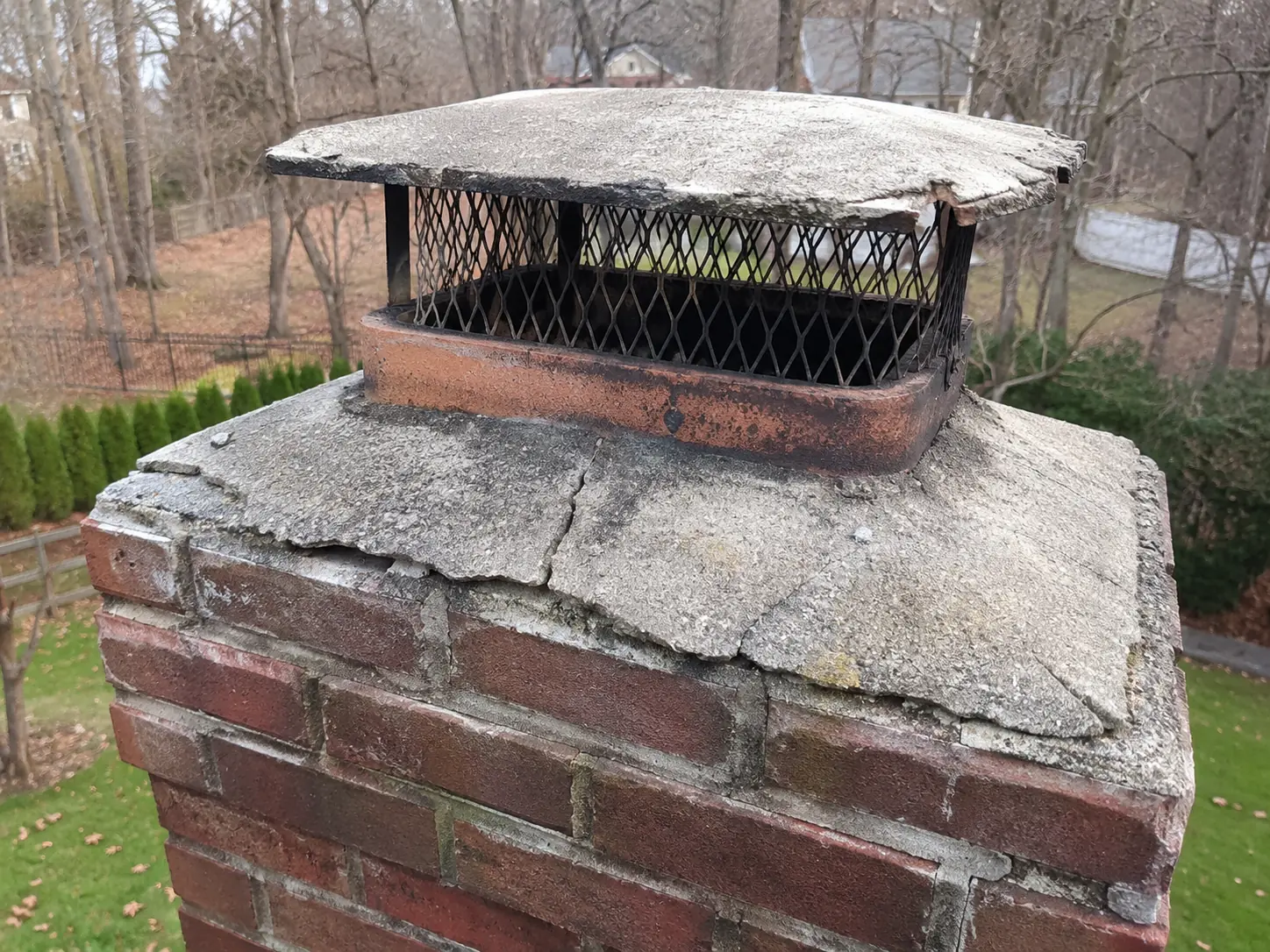 Damaged chimney top before repair